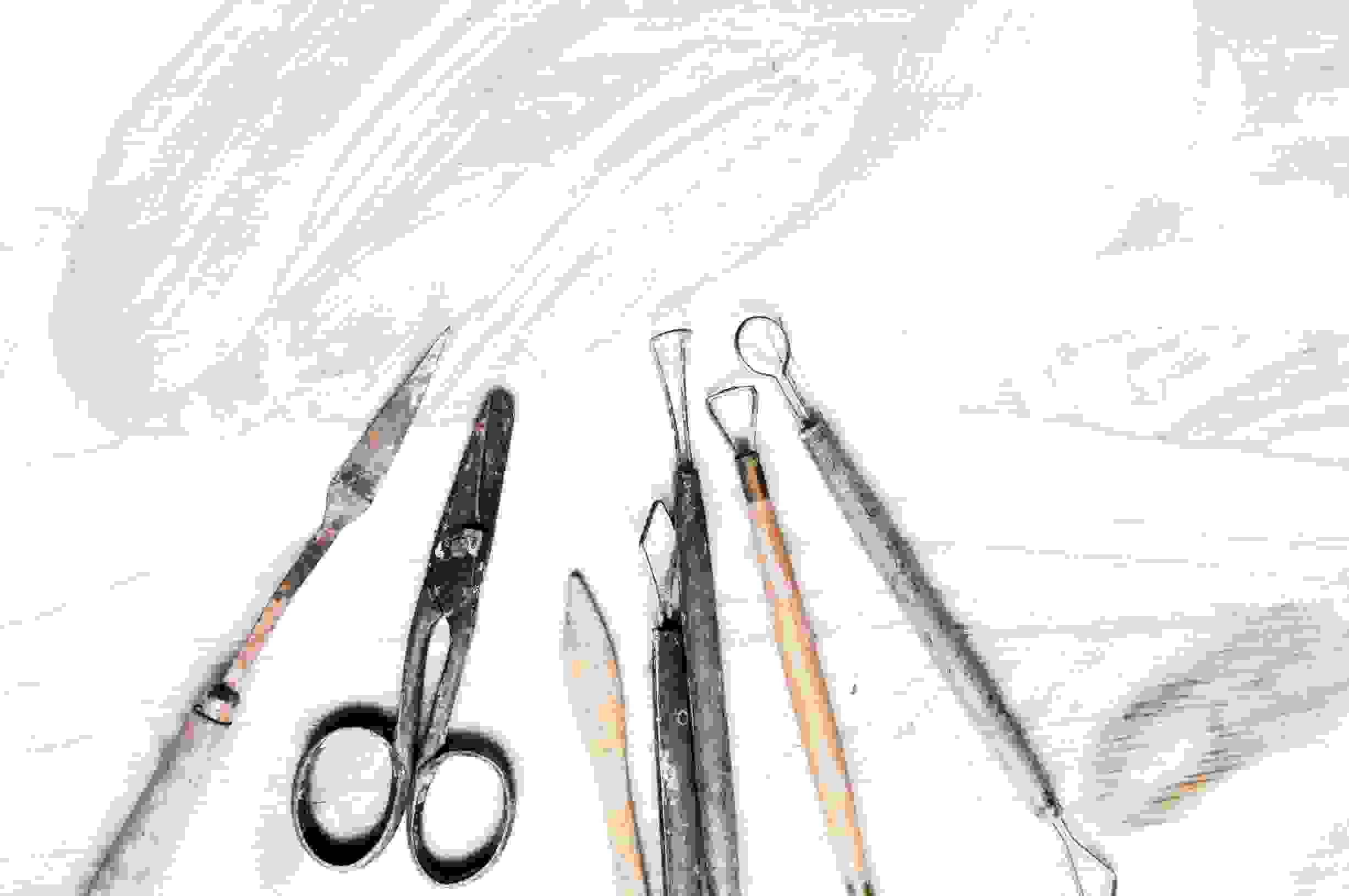 A selection of craft tools on a painted bench